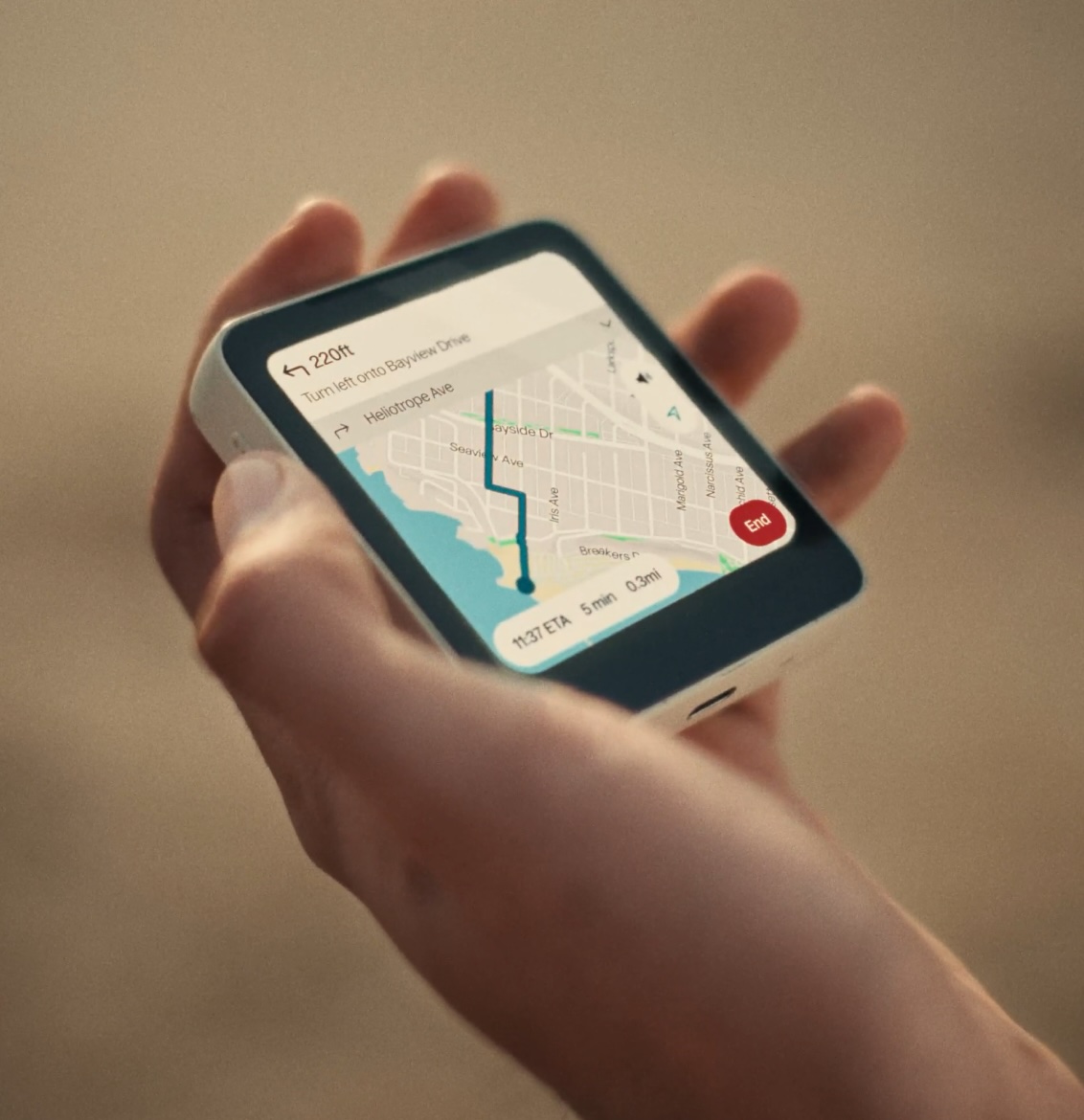 The Meadow ultra-compact smartphone with minimalist design, no browser, social media, or email, displayed on a wooden desk with natural lighting