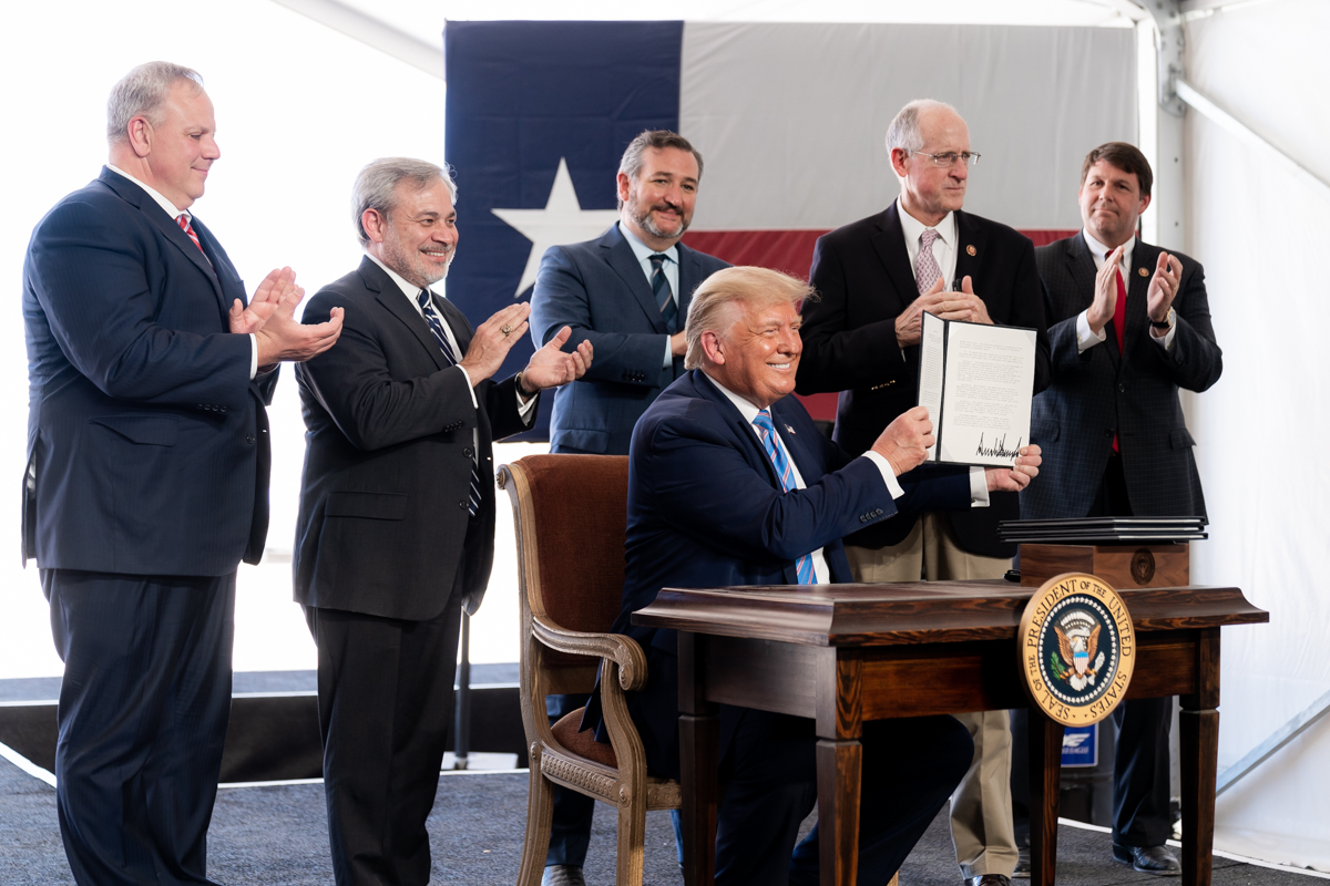 President Donald Trump at an oil rig, symbolizing the impact of his policies on the petrodollar and global oil markets.