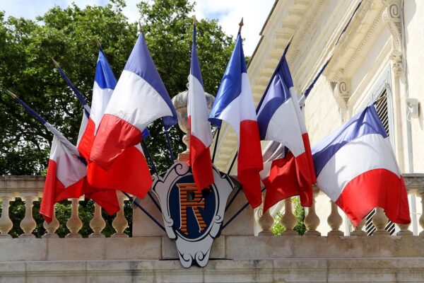 Multiple French flags waving, symbolizing France’s superpower and global influence