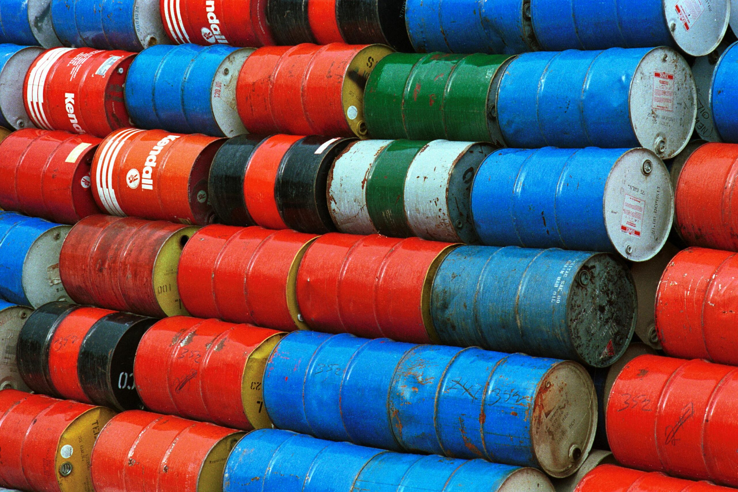 Stacked oil barrels released by International Energy Agency representing global emergency petroleum reserves and supply stabilization efforts