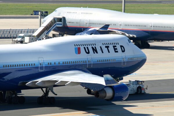 Two United Airlines passenger planes parked at an airport gate showing pressure on budget airlines amid rising fuel costs and $2.5 billion bailout concerns | bdesk.news