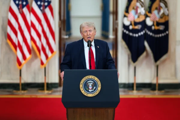Donald Trump speaking during a formal public event, representing his presidency and fact-check findings on 30,573 false or misleading claims (bdesk.news)